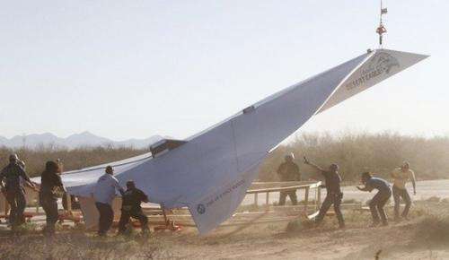 800 pound paper airplane and people trying to fly them